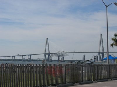 The new bridge crosses over the old bridge which is...
